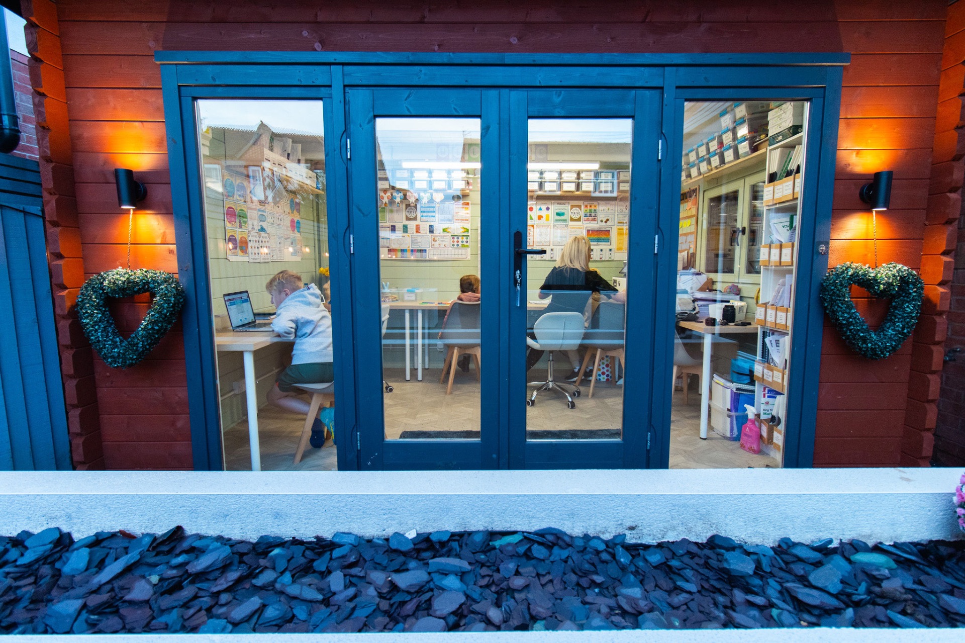 The Tutor Movement's purpose-built garden teaching room with the doors open
